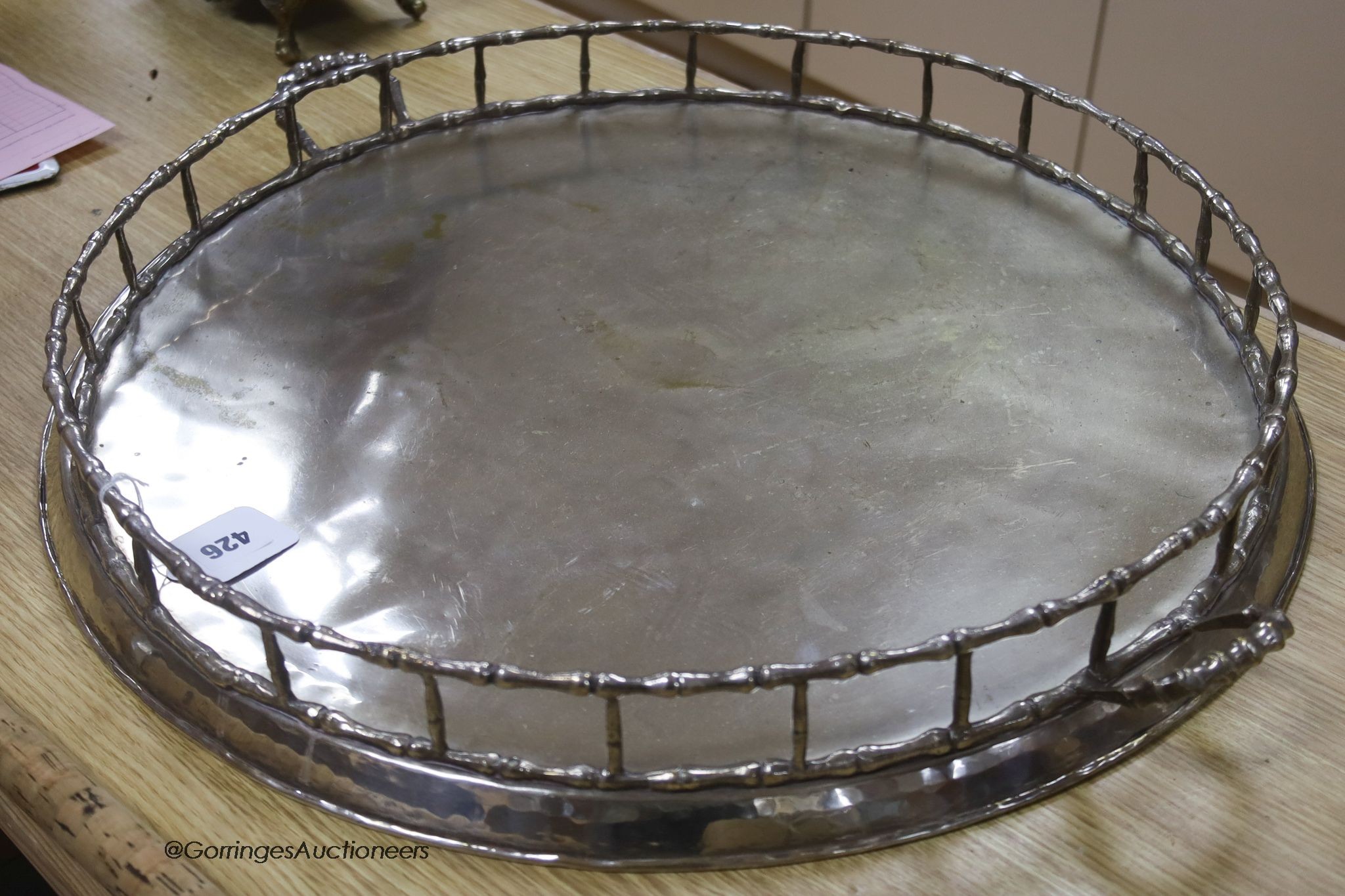 A large Iranian plated two-handled circular tray, 64cm handle to handle